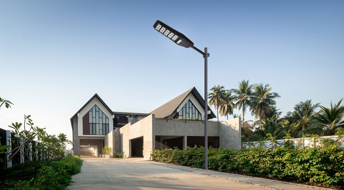 black solar street light installed in front of a house